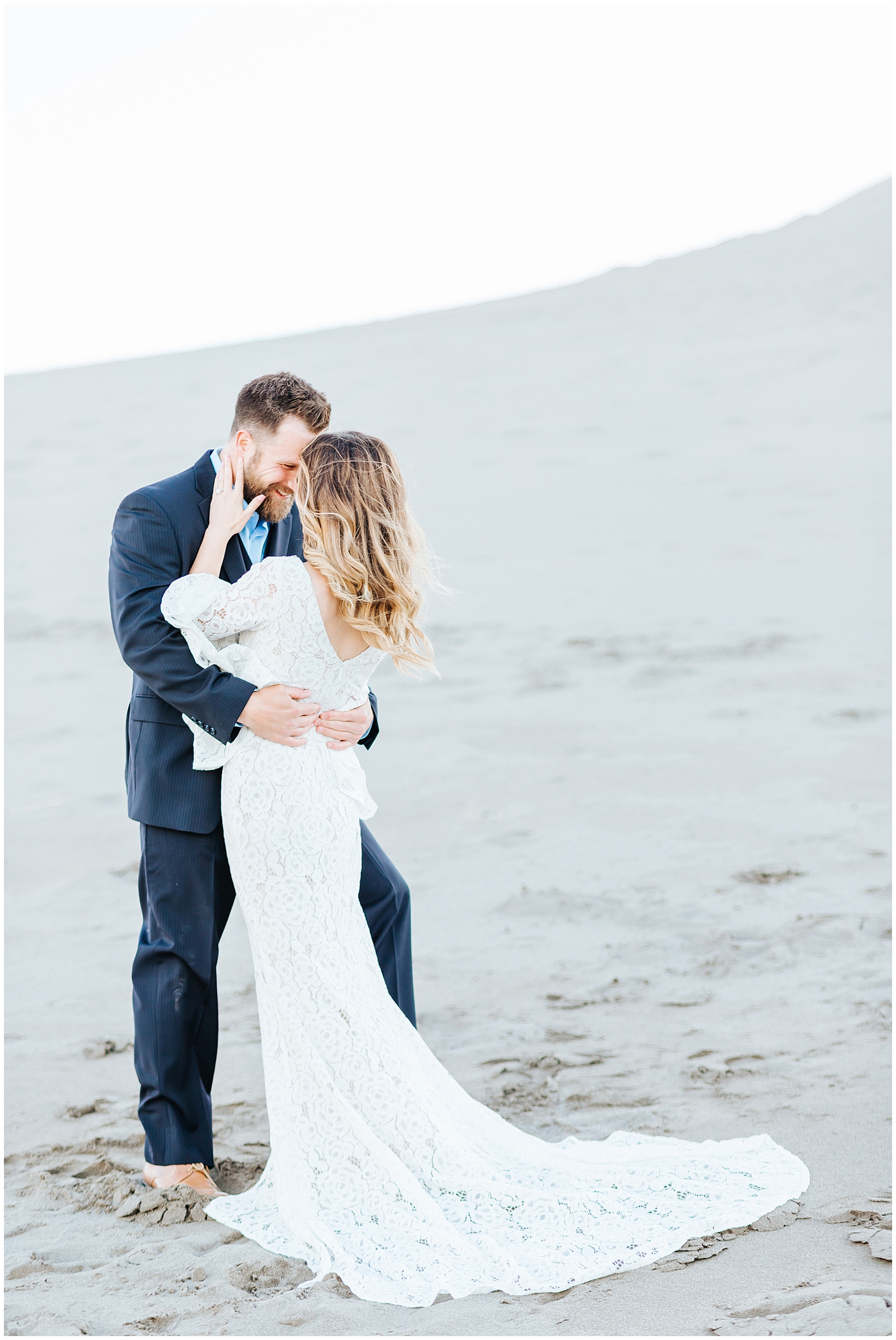 Dreamy Sand Dunes Engagement Photos in White Lacy Lulu's Dress and Navy Suit