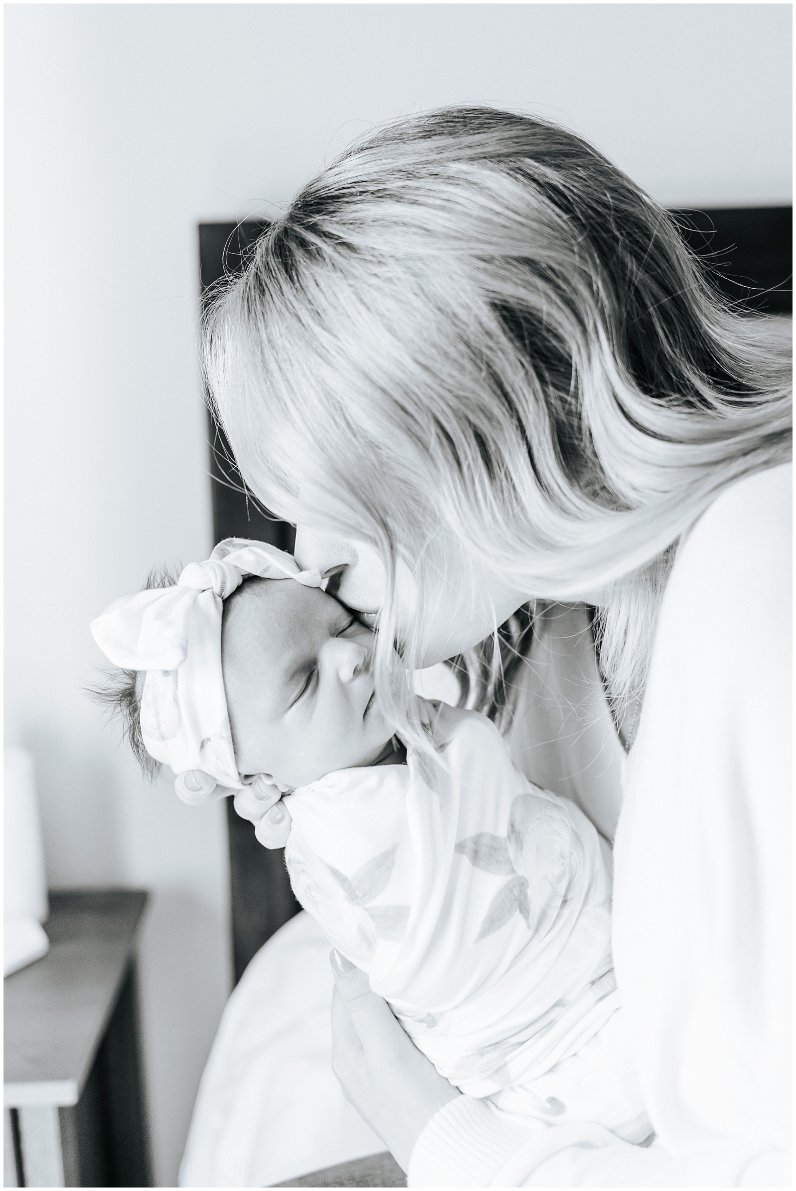 Mom kissing baby at newborn lifestyle session
