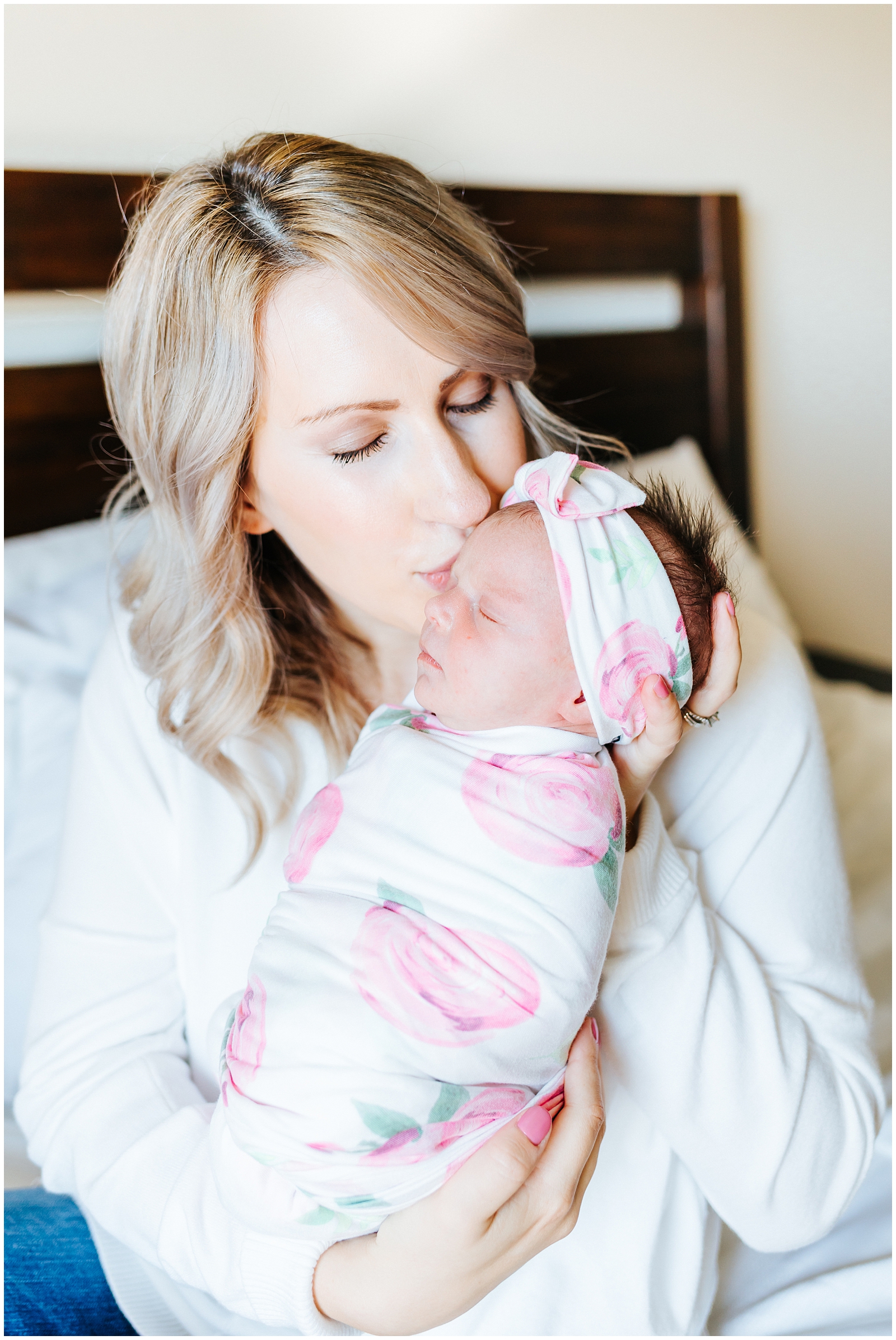 Mom Kissing baby at newborn lifestyle session 