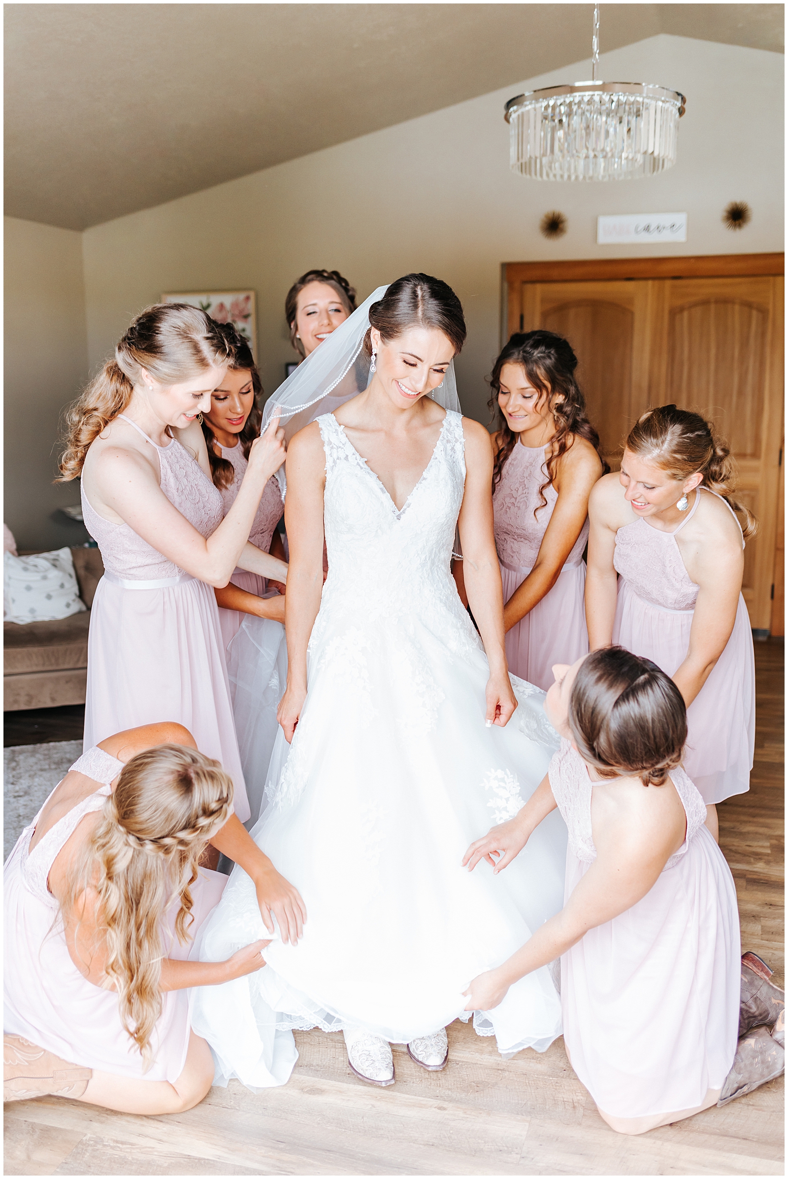 Bridesmaids helping Bride get ready at rustic chic Still Water Hollow Wedding