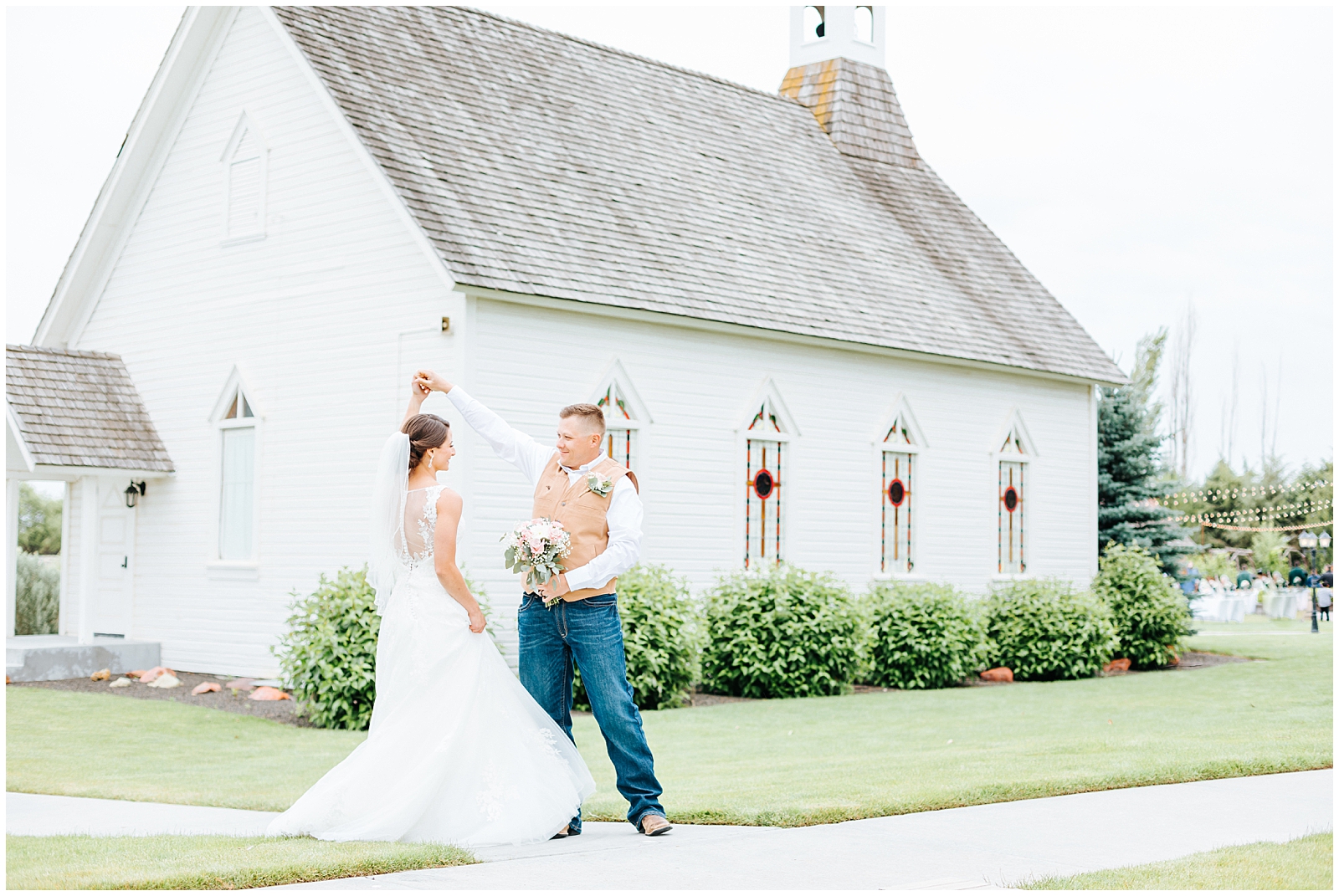 Twirling in front of the white chapel at Still Water Hollow Wedding Venue in Nampa, Idaho