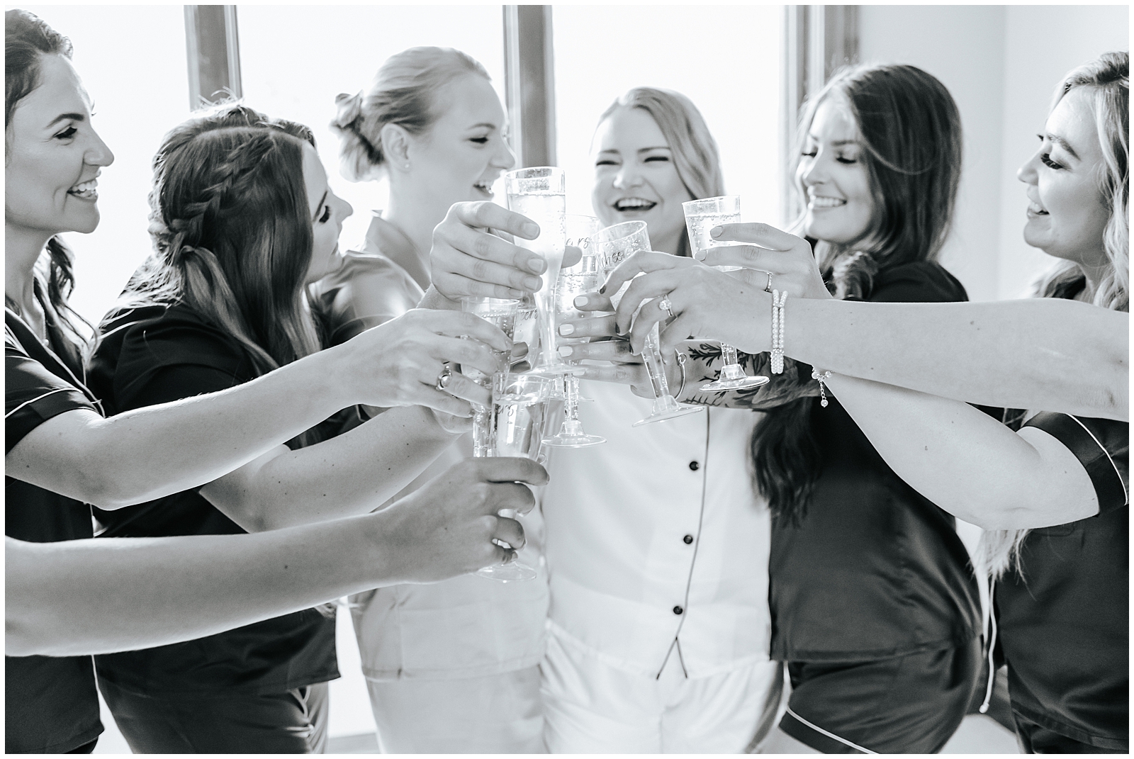 Bridesmaids matching pajamas toast before wedding ceremony