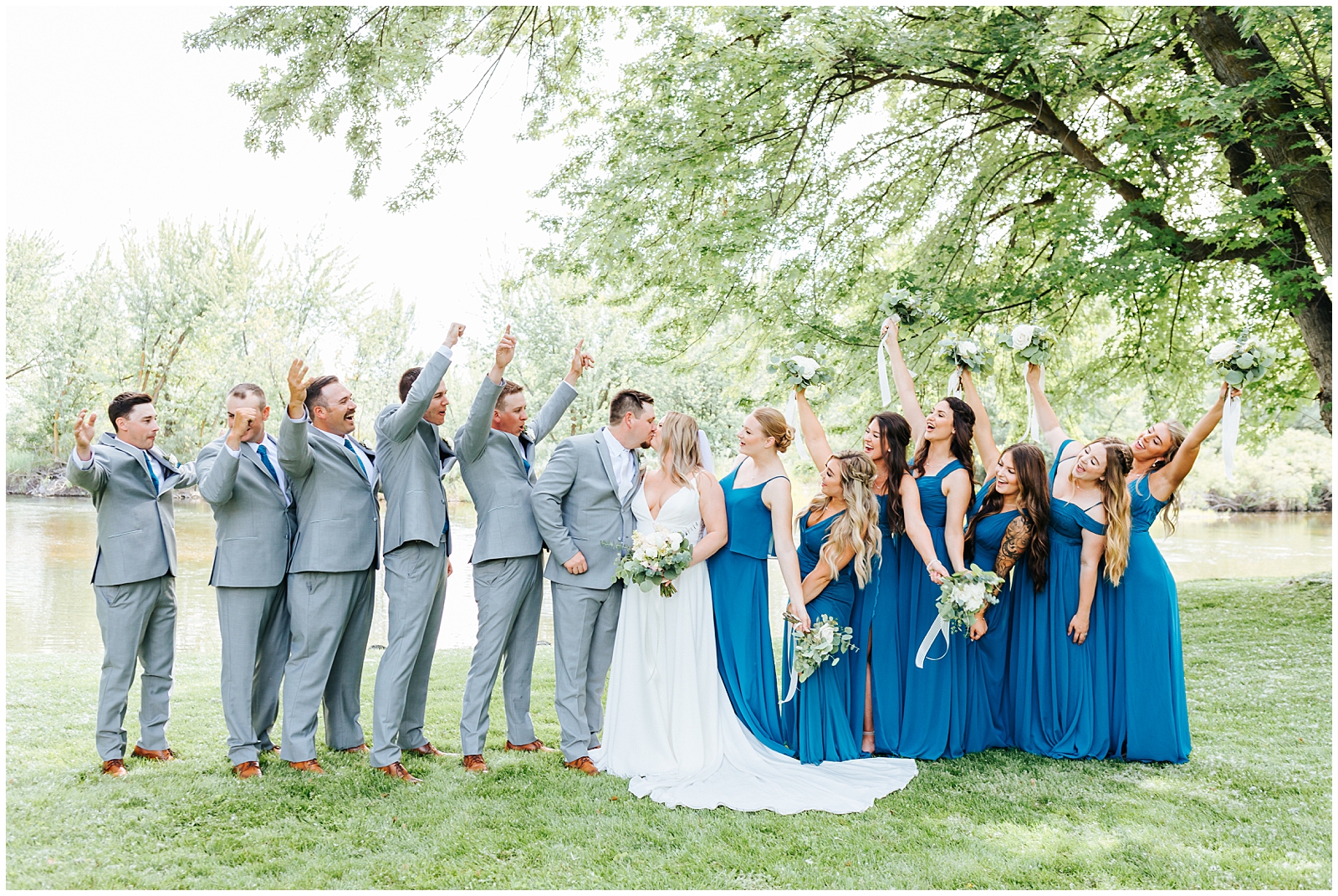 Bridal Party Cheering while the bride and groom kiss