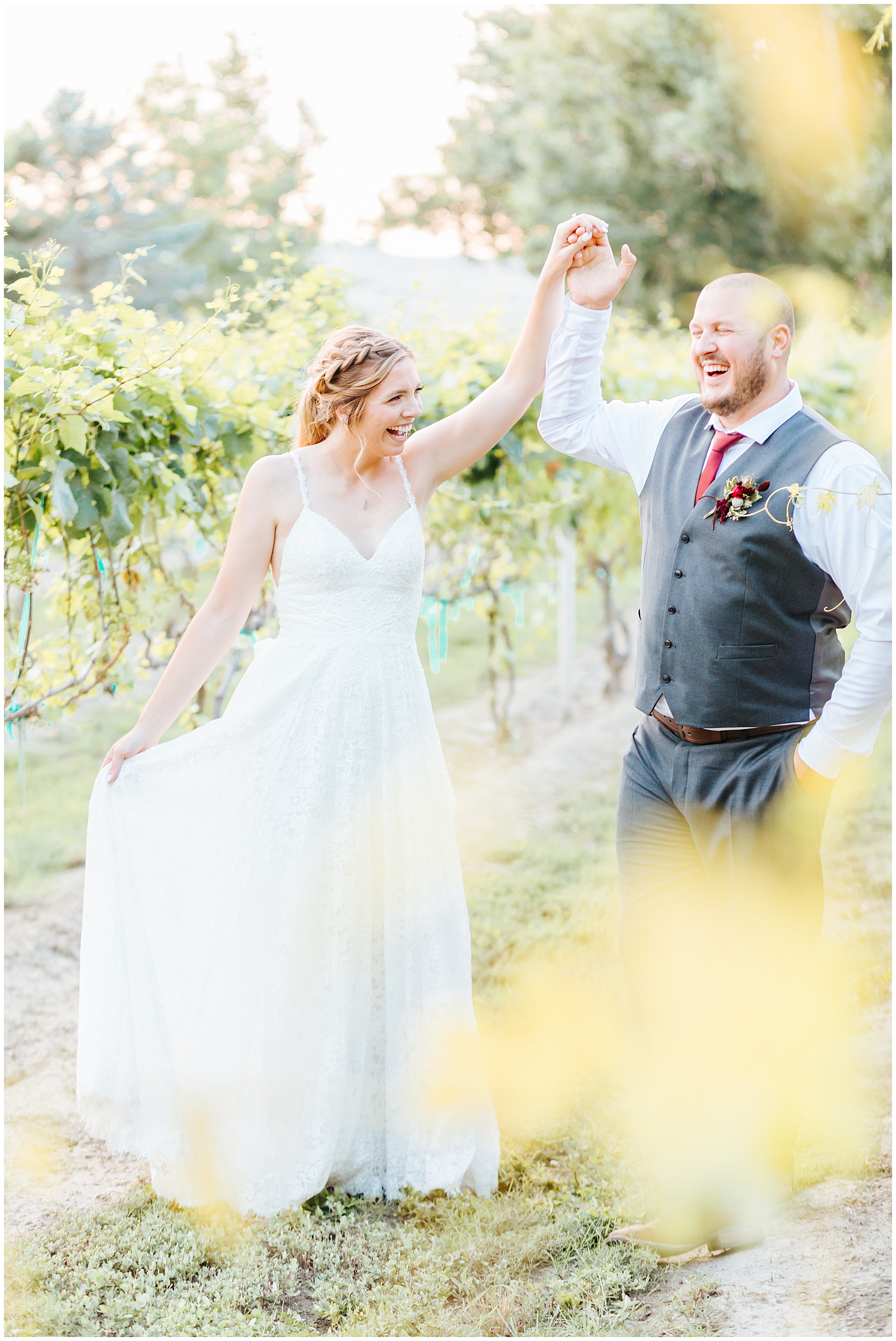 Giggles and Laughter Between the bride and groom during vineyard portraits at Fox Canyon Vineyards Wedding