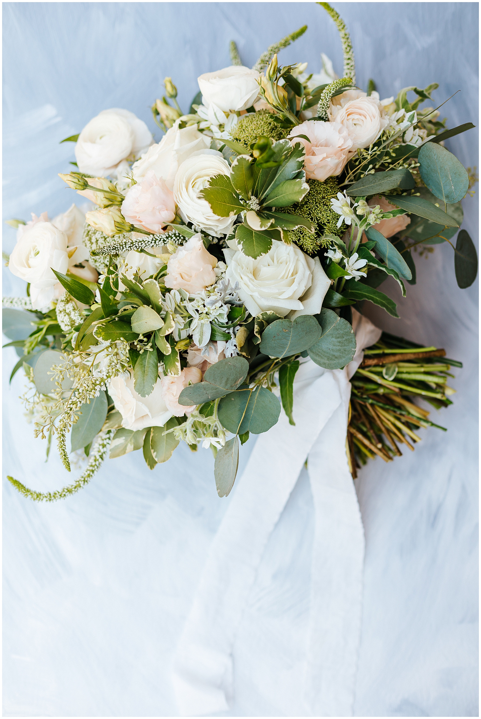 Bridal Bouquet by Posies Floral Design with creams, whites, and light blush pink roses