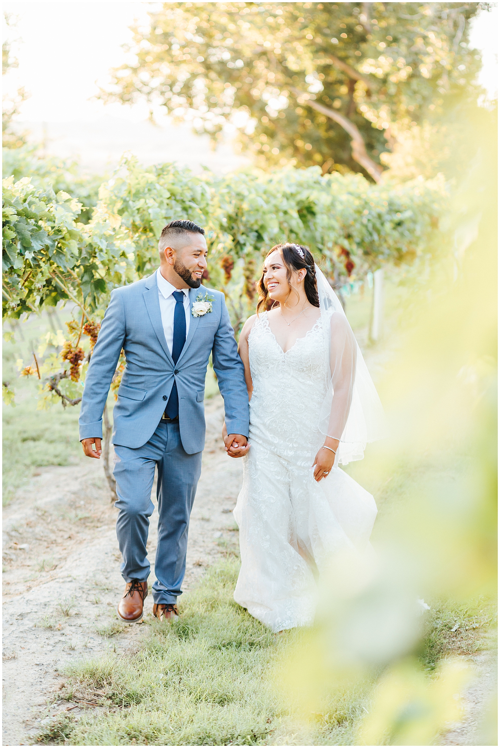 Wedding Day Posing - Couple Walking and Smiling at Each other in the Vineyards