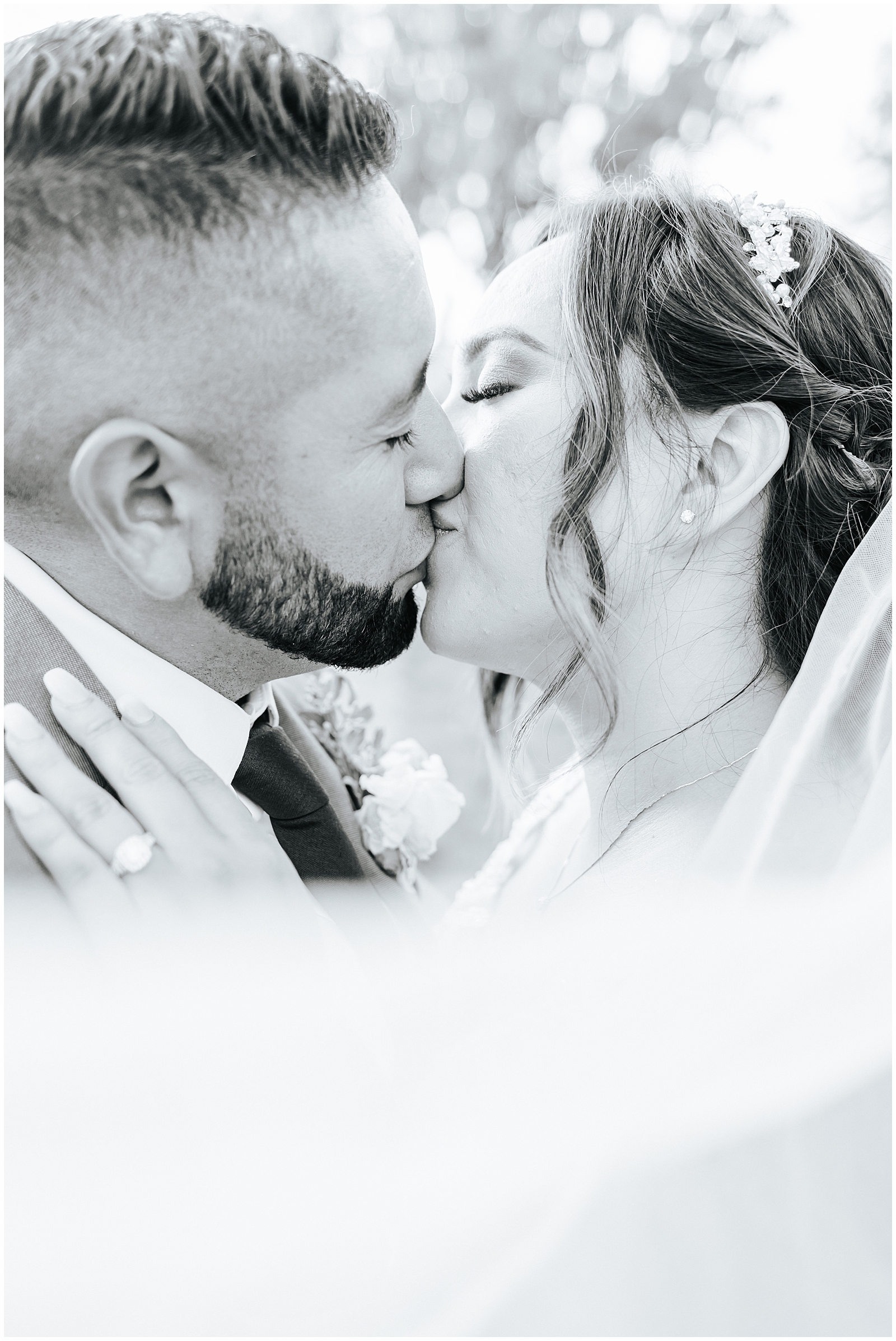 Black and White Bride and Groom Portrait with Swooping Veil and Couple Kissing