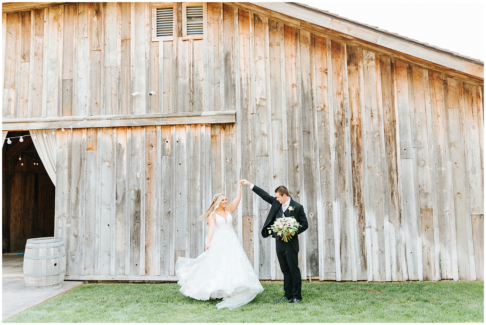 Bride and Groom Twirling by Barn at August Still Water Hollow Wedding 