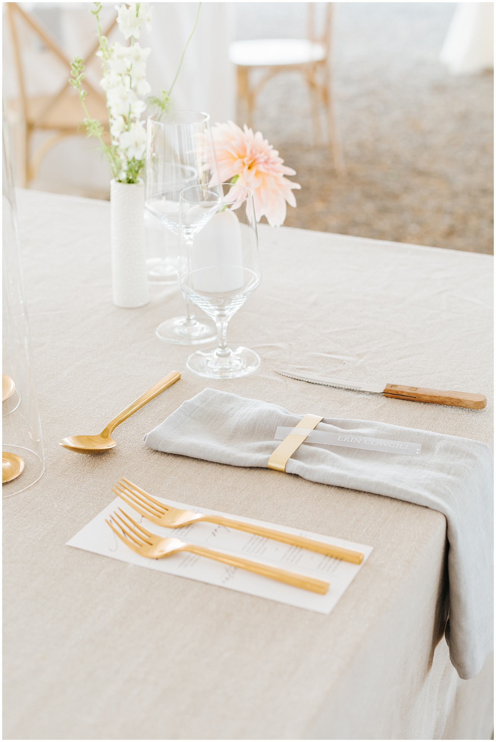 Wedding Reception Tableware and Acrylic Place Settings on Linen Table Cloth with Gold Silverware