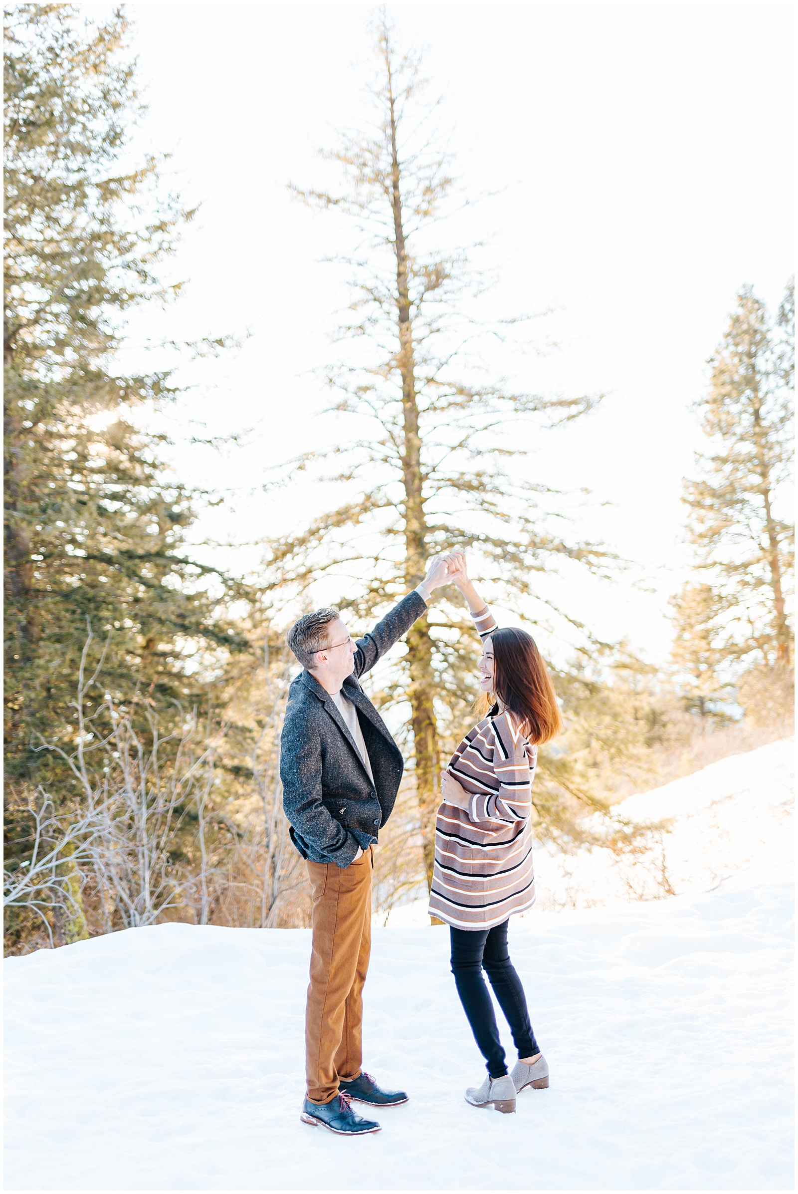 Winter Mountain Engagement Session at Bogus Basin Couple Twirling and Dancing