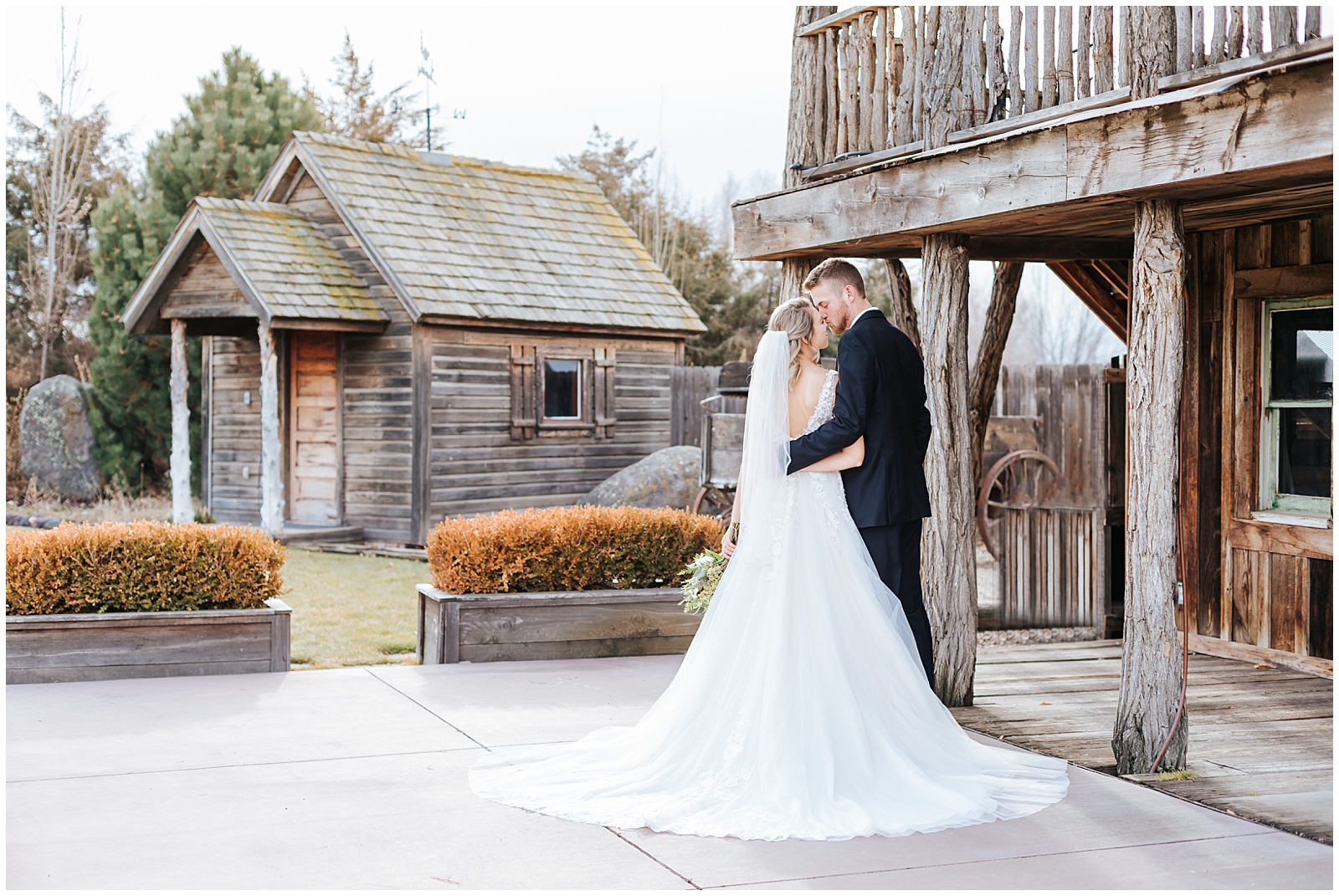 Winter Still Water Hollow Wedding Bride and Groom Snuggling by Rustic Barn