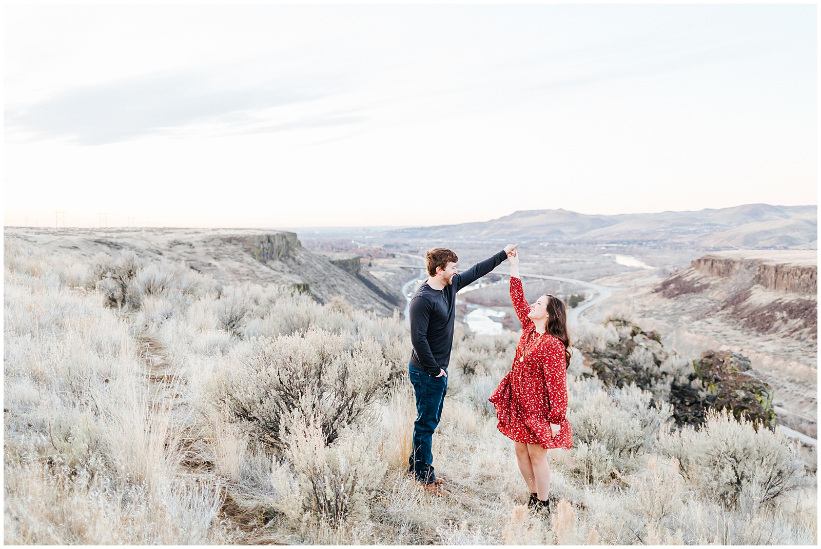 Boise Foothills Desert Engagement Twirling in front of valley
