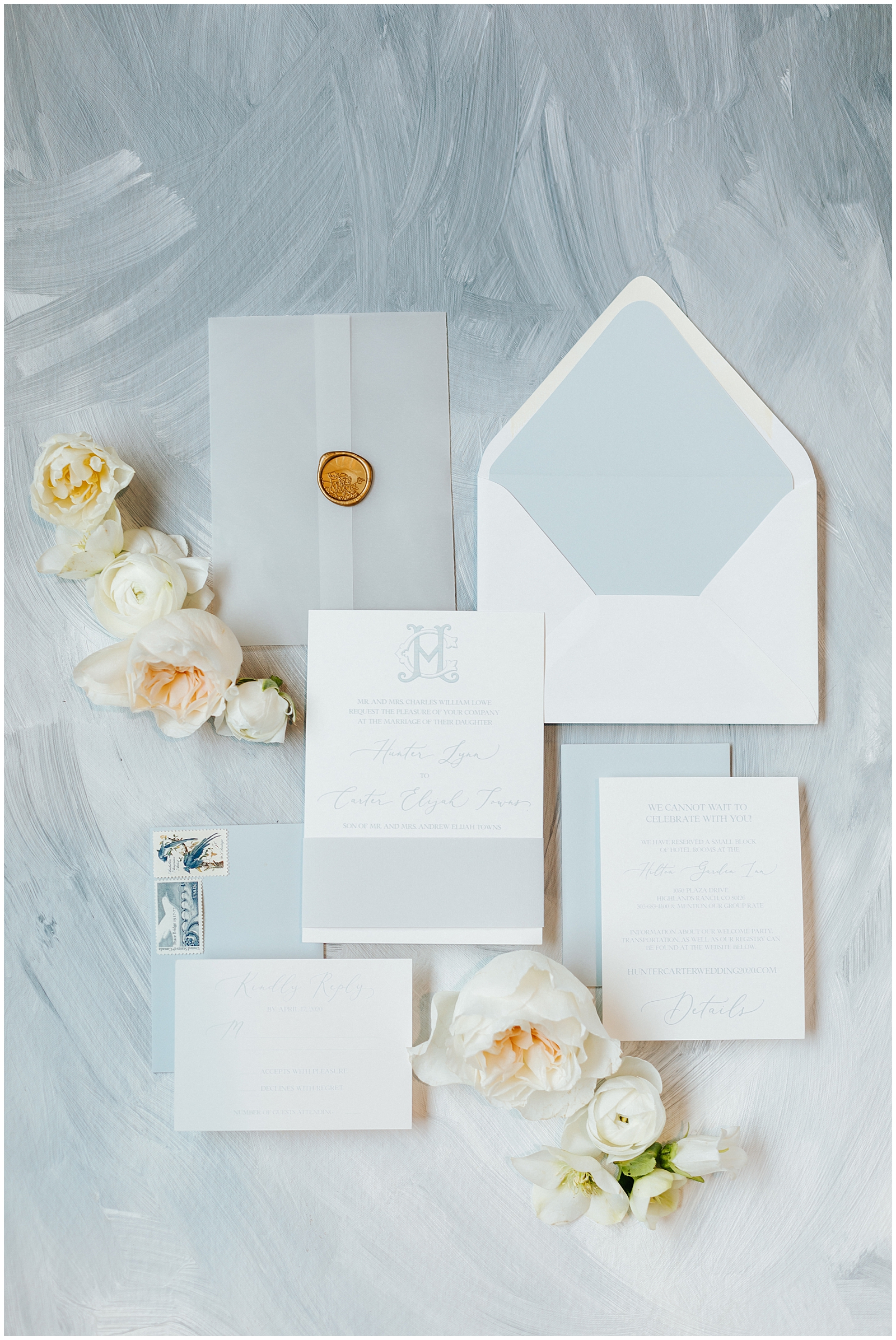 Dusty Blue Wedding Invitation Suite Flatlay with Florals, vintage stamps, and wax seal with vellum at Classic Elegant Florida Wedding