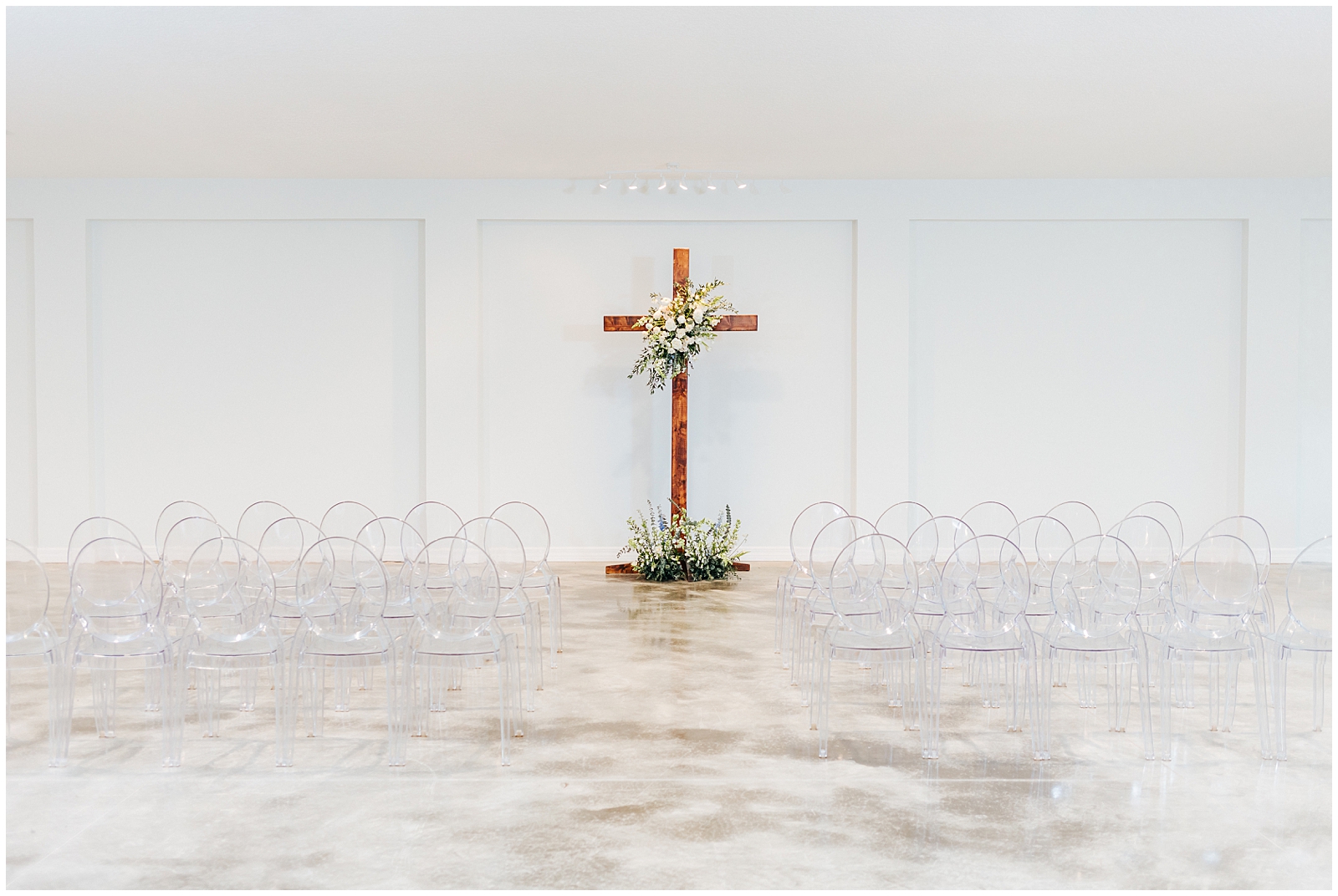 Ceremony with Ghost Chairs and Wooden Cross inside Simpson Lakes Event Center in Dade City, Florida
