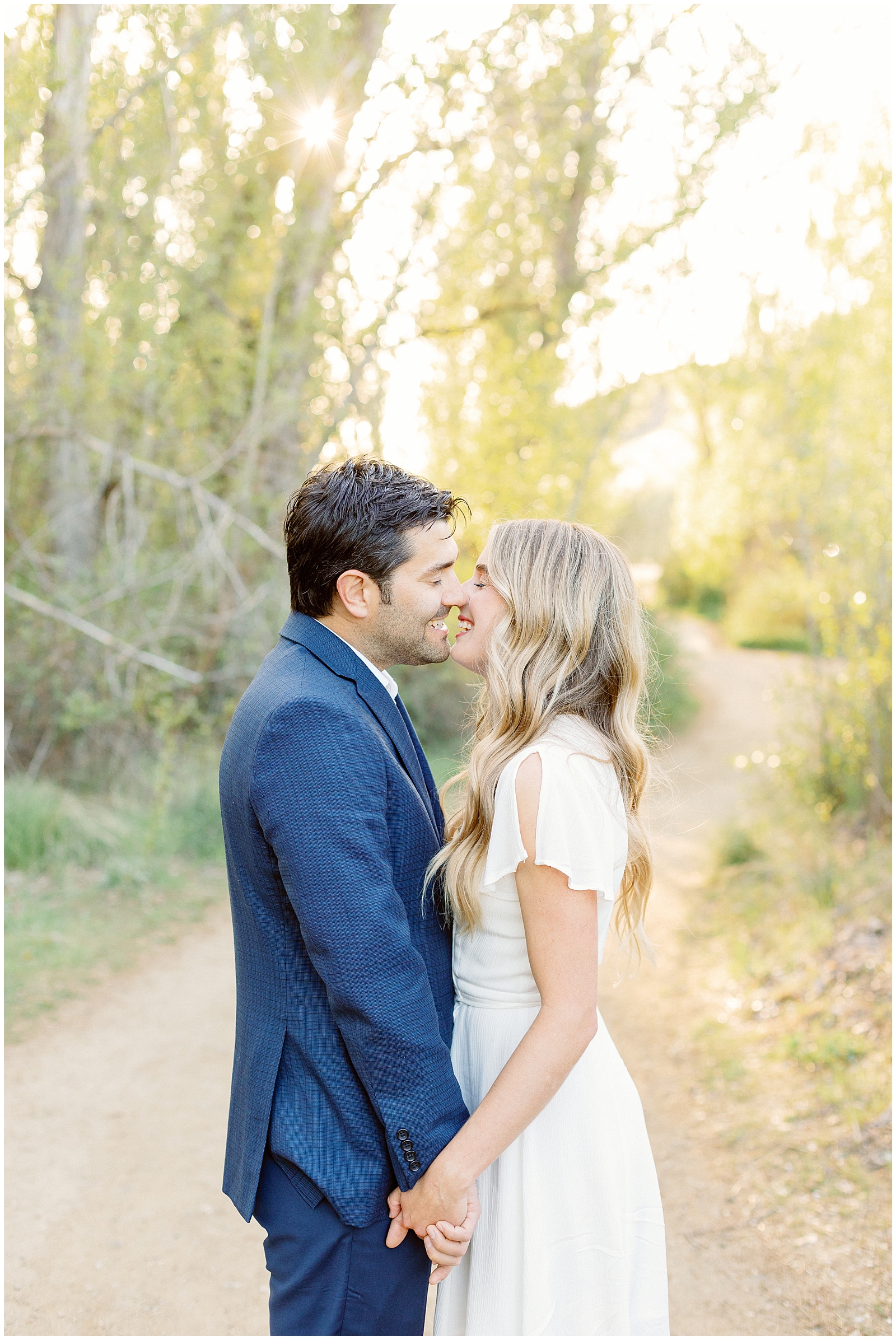 Couple Giggling after a Kiss - Elegant Boise Foothills Engagement Session - Boise Idaho Wedding Photographers