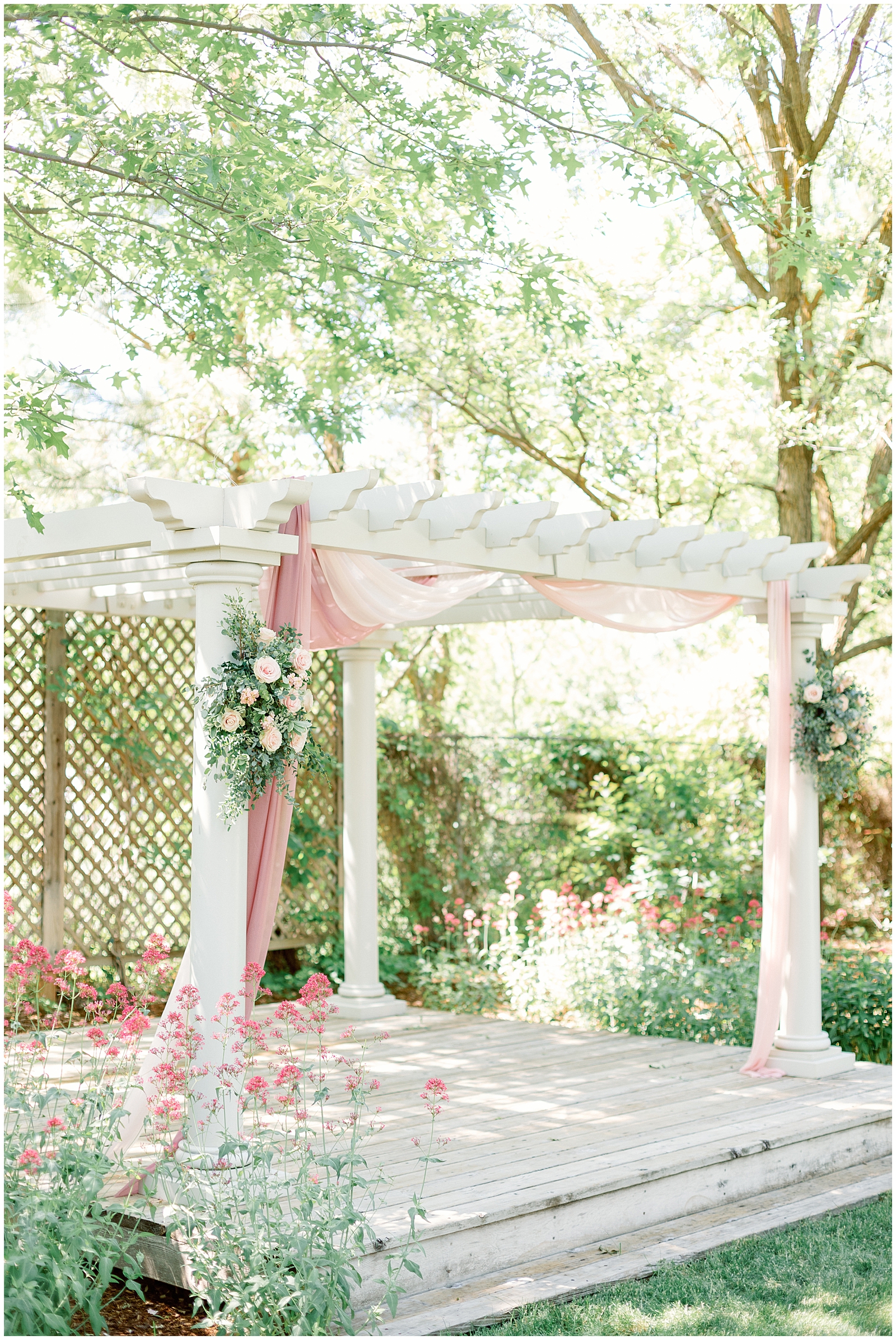 Dreamy Dusty Rose Garden Ceremony with white arbor at Dreamy Idaho Garden Wedding